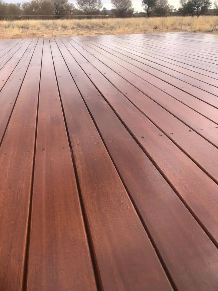A Close Up of a Wooden Deck With a Field in the Background  — NHM Painting & Projects in Ciccone, NT