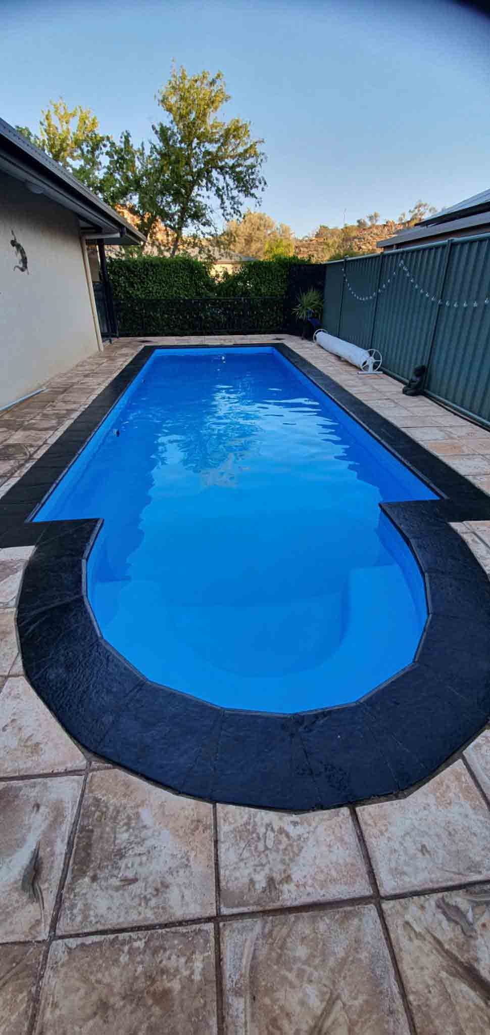 A Large Swimming Pool Filled With Blue Water in a Backyard  — NHM Painting & Projects in Ciccone, NT