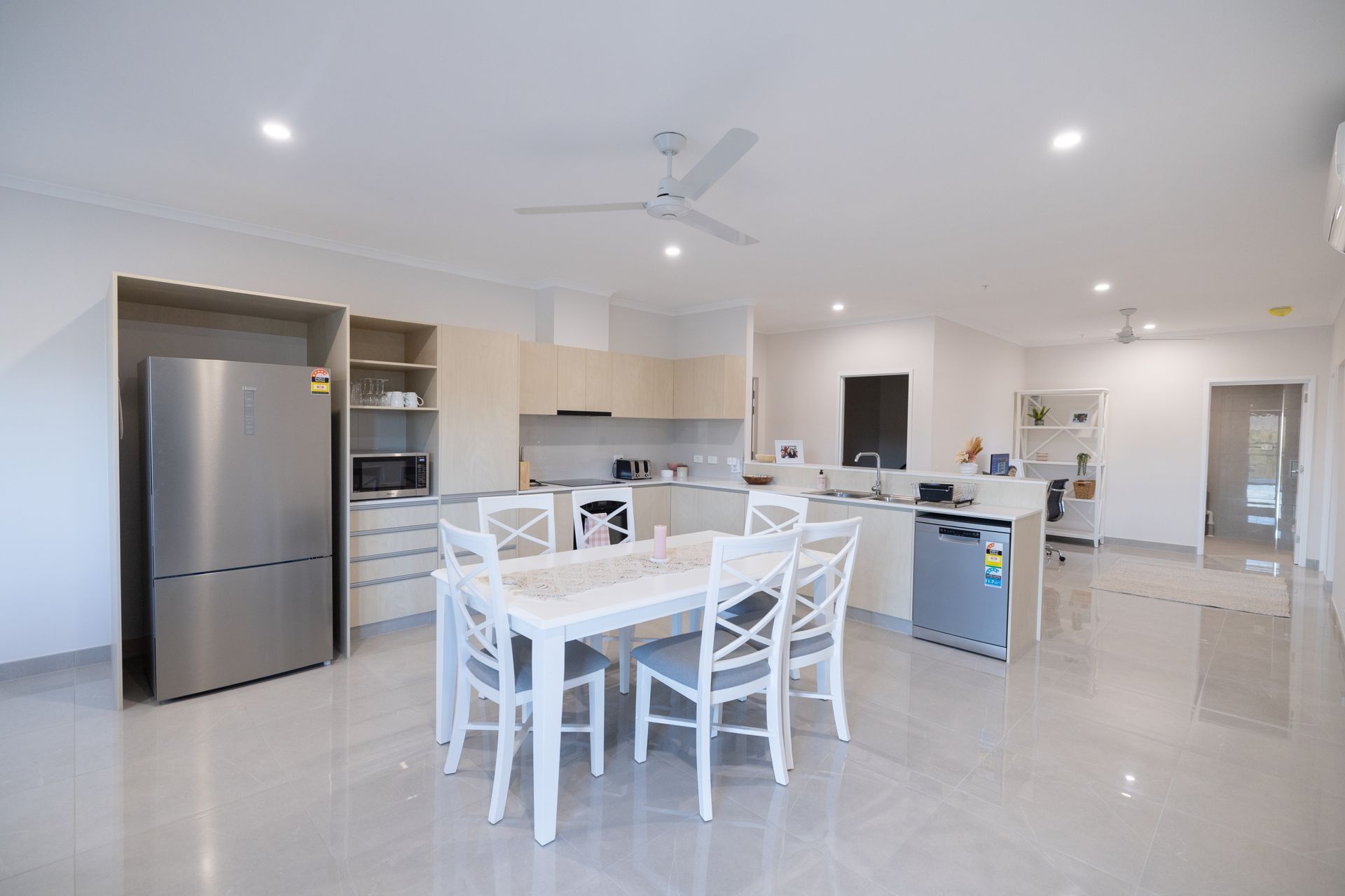 A Kitchen With a Dining Table and Chairs and a Refrigerator  — NHM Painting & Projects in Ciccone, NT
