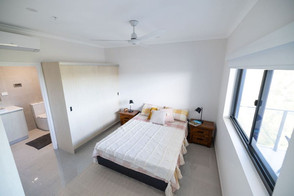 A Bedroom With a Bed, Nightstands, and a Ceiling Fan — NHM Painting & Projects in Ciccone, NT
