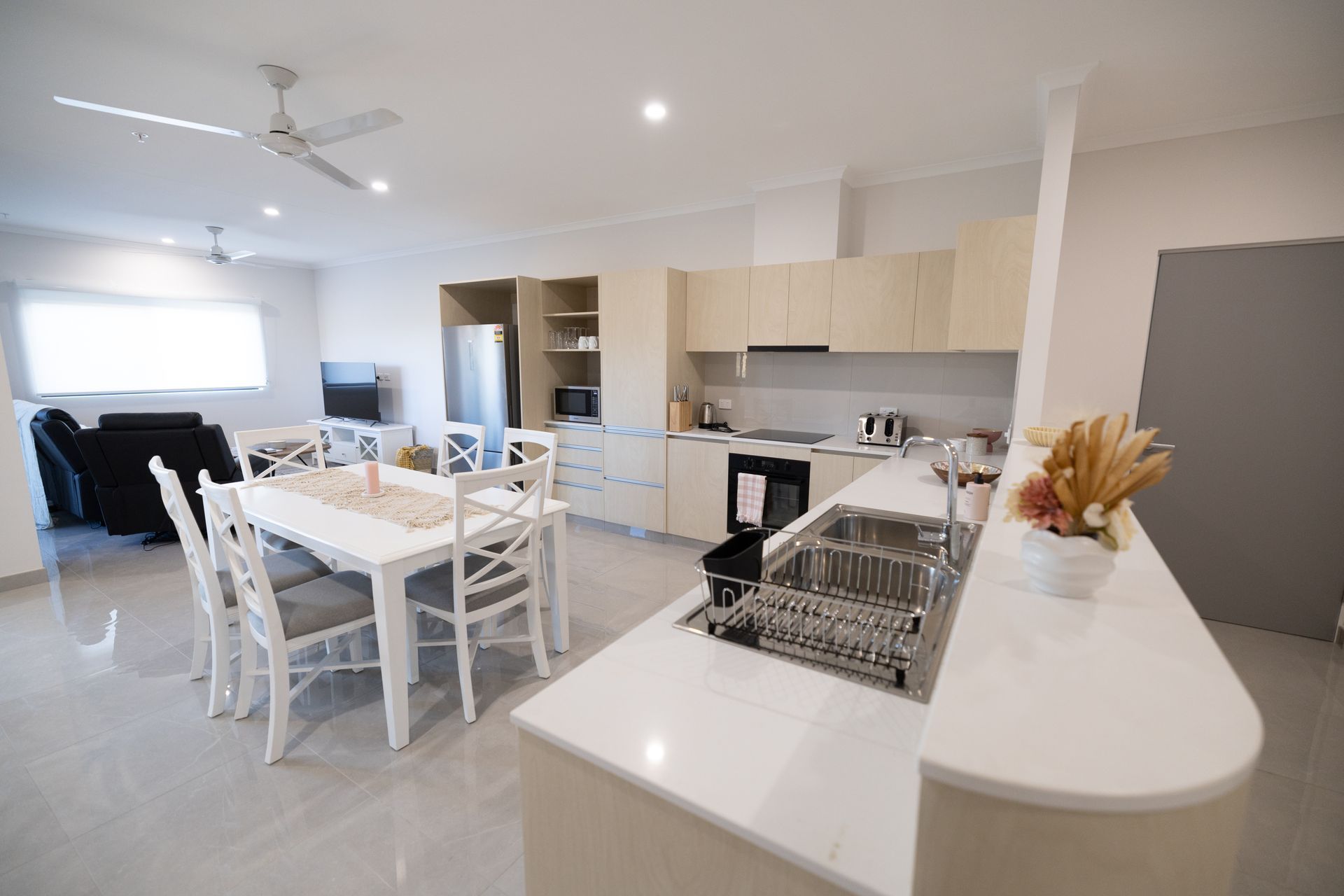 A Kitchen With a Dining Table and Chairs and a Sink  — NHM Painting & Projects in Ciccone, NT