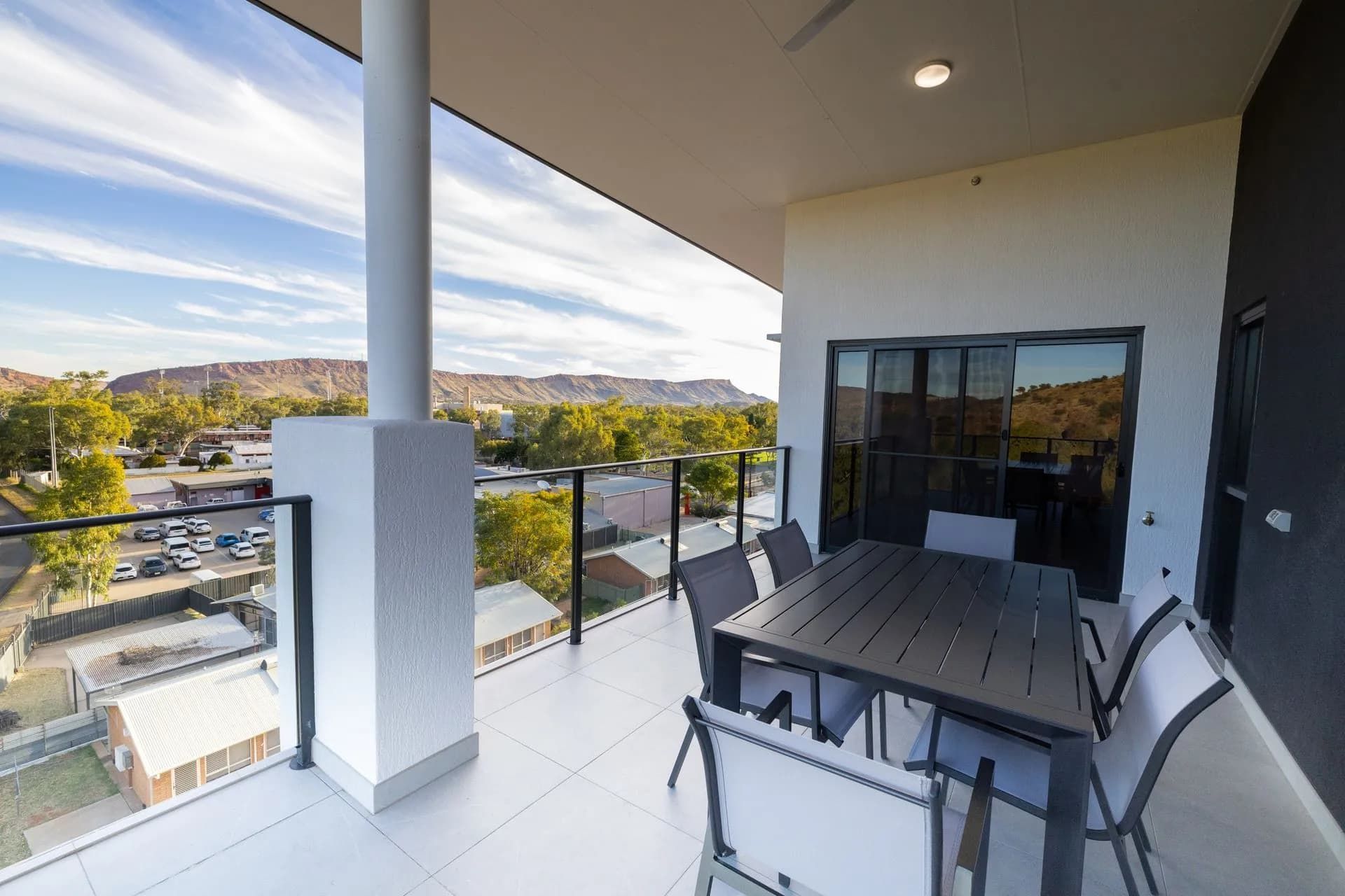 A Balcony With a Table and Chairs and a View of a City  — NHM Painting & Projects in Ciccone, NT