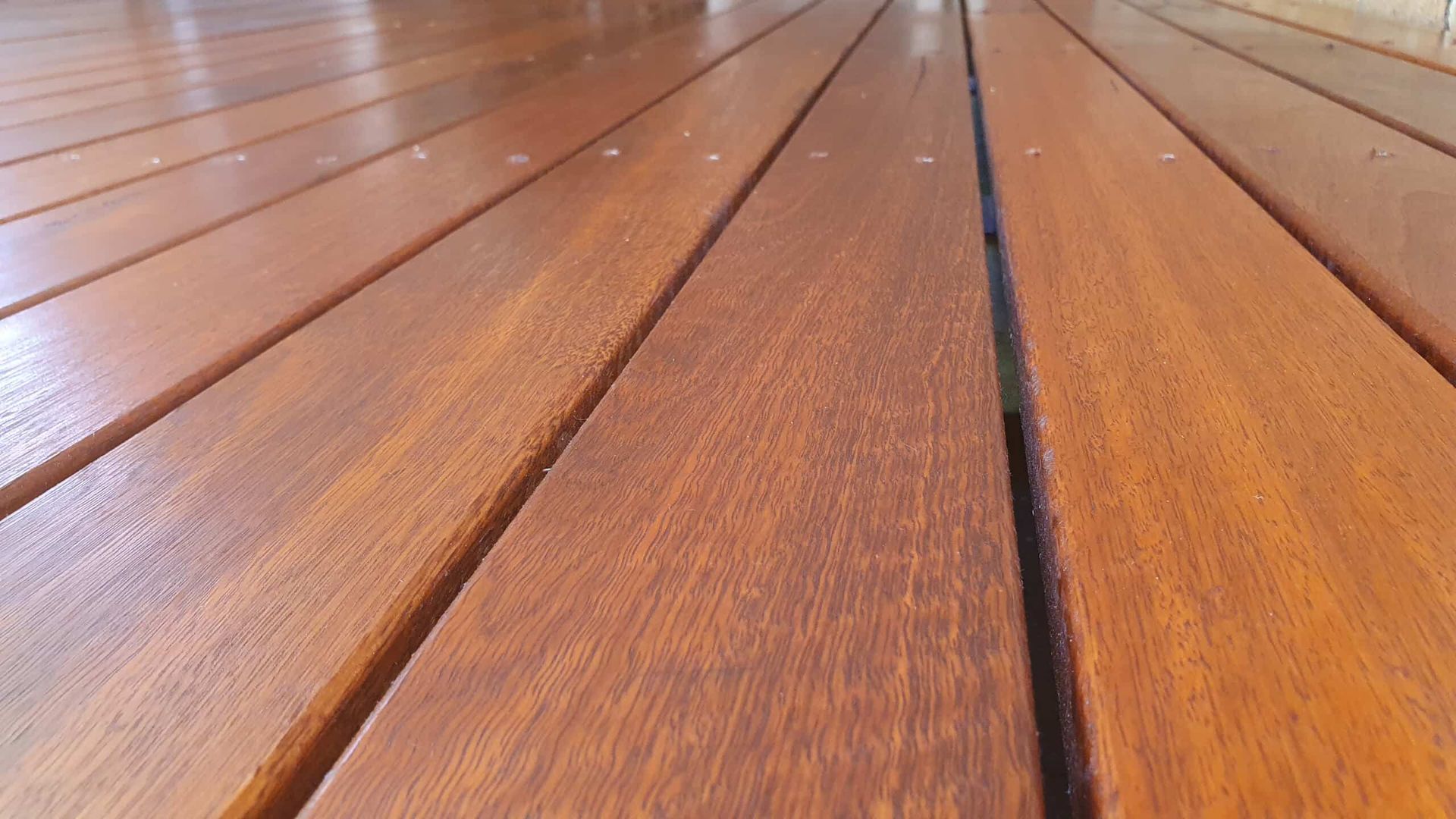 A Close Up of a Wooden Deck With a Black Border — NHM Painting & Projects in Ciccone, NT