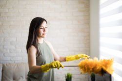 Woman Dusting — Amherst, OH — Energy 1 Heating & Air Conditioning