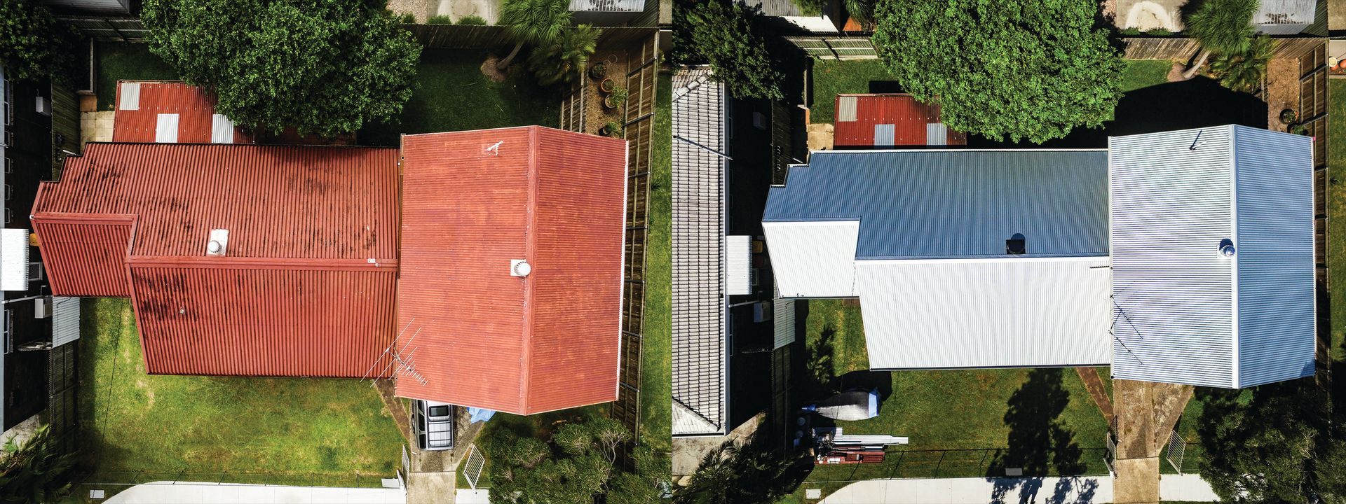 Overhead view of two houses with red and blue roofs, separated by a narrow driveway and greenery
