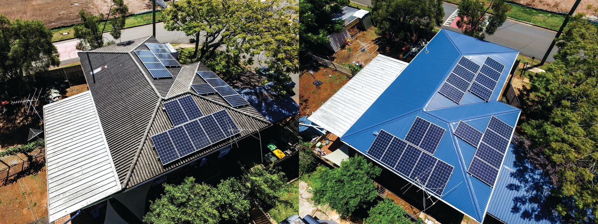 Aerial view of two houses with solar panel roofs, one black and one blue, surrounded by trees.