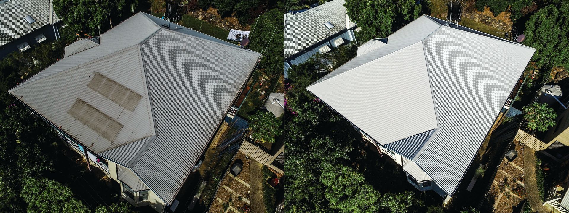 Aerial view of two rooftops, one gray and one white, surrounded by trees and neighboring houses.
