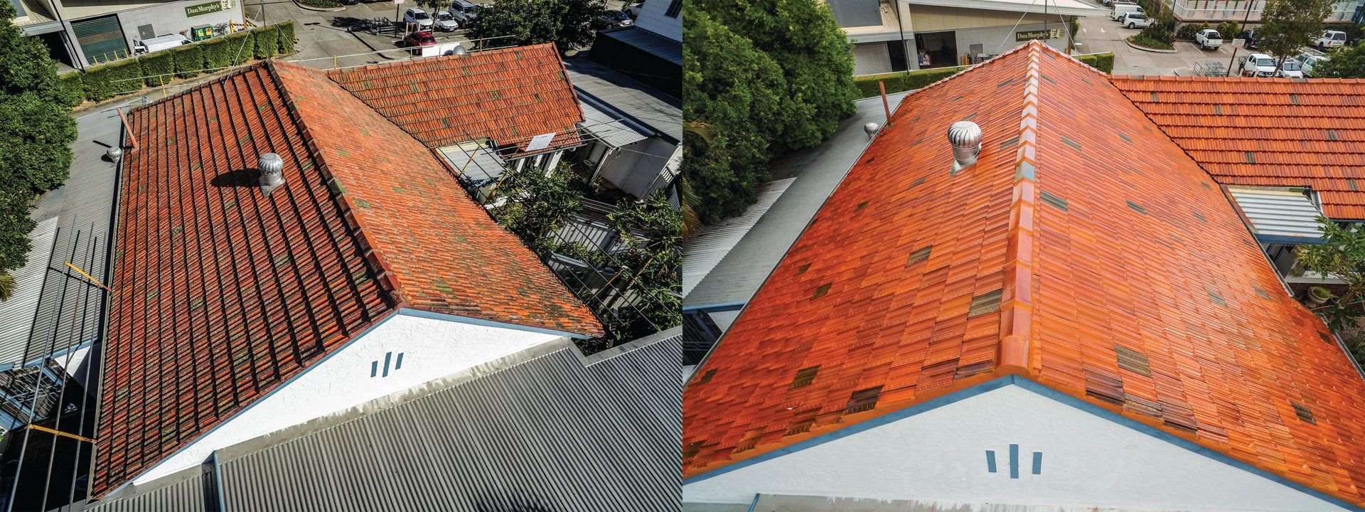 Aerial view of several red-tiled rooftops on houses surrounded by green trees.