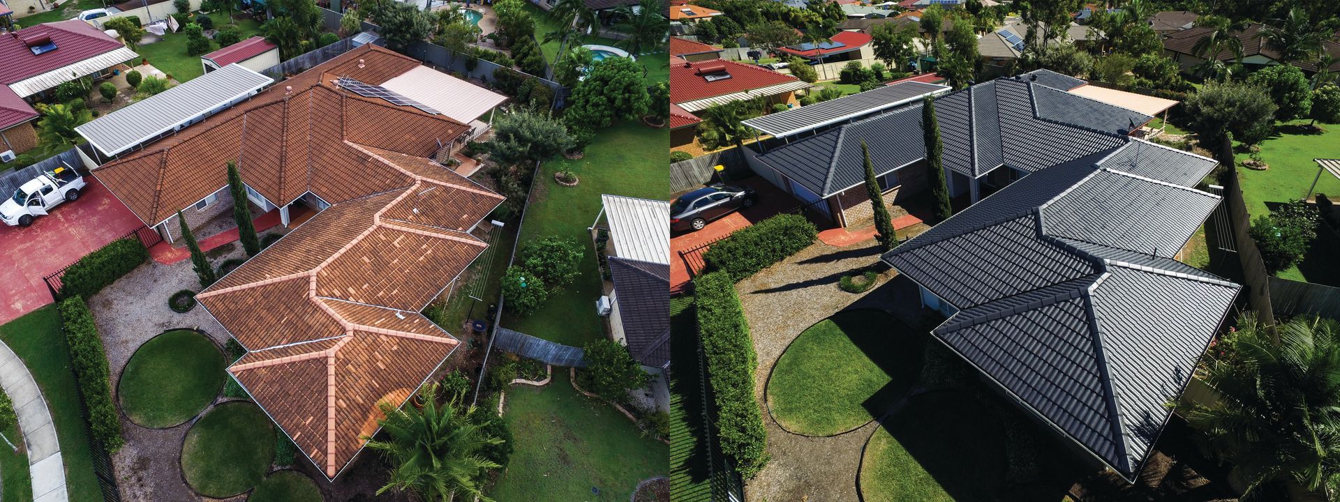 Aerial view of several houses with red and dark roofs surrounded by trees and greenery.