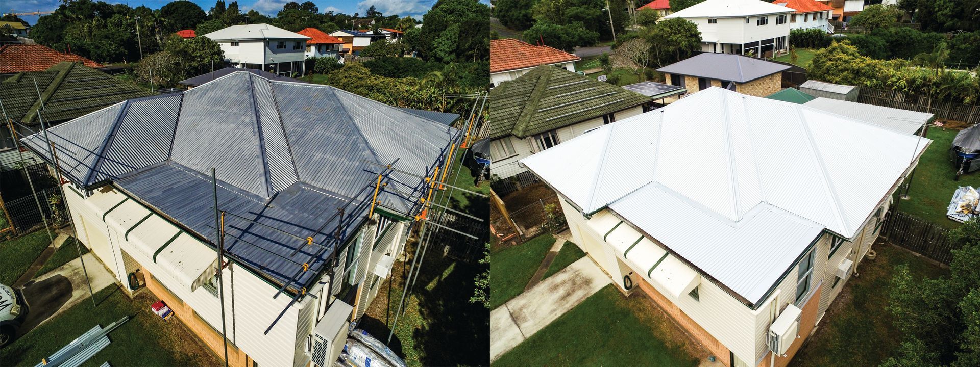 Aerial view of two houses with large metal roofs, one dark and one white, in a residential neighborhood.