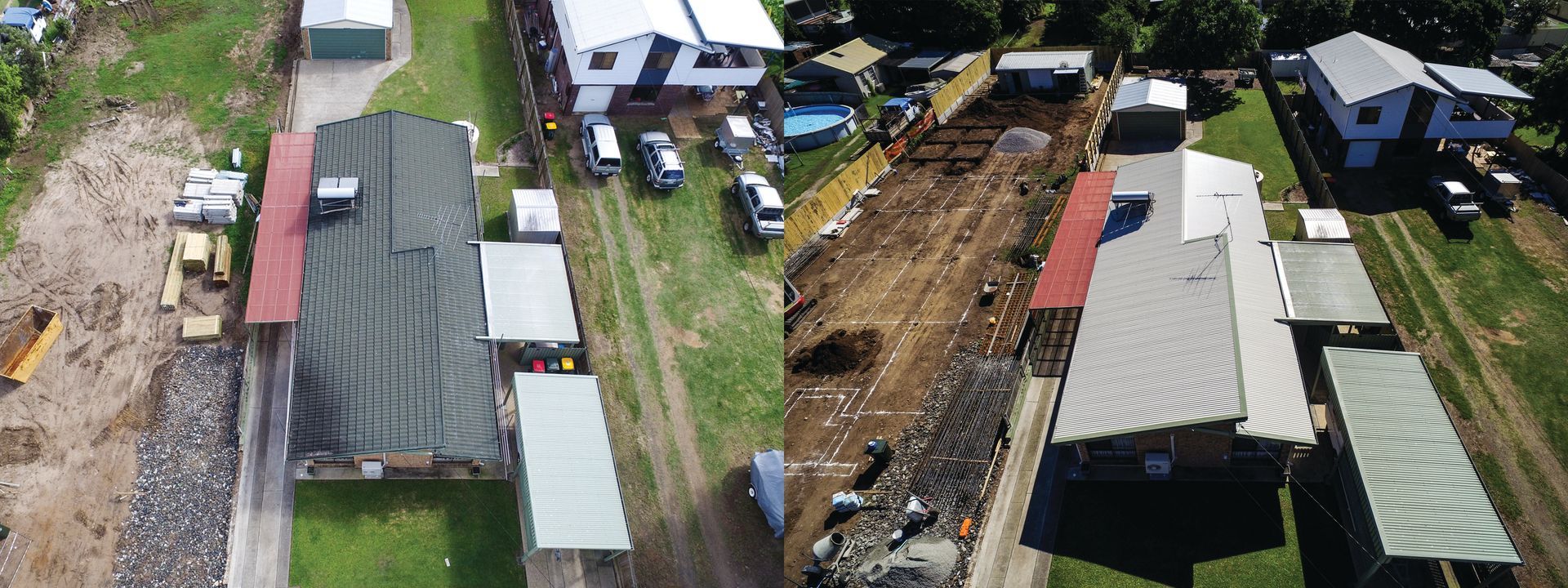 Aerial view of a residential area with homes, narrow dirt roads, and parked vehicles.