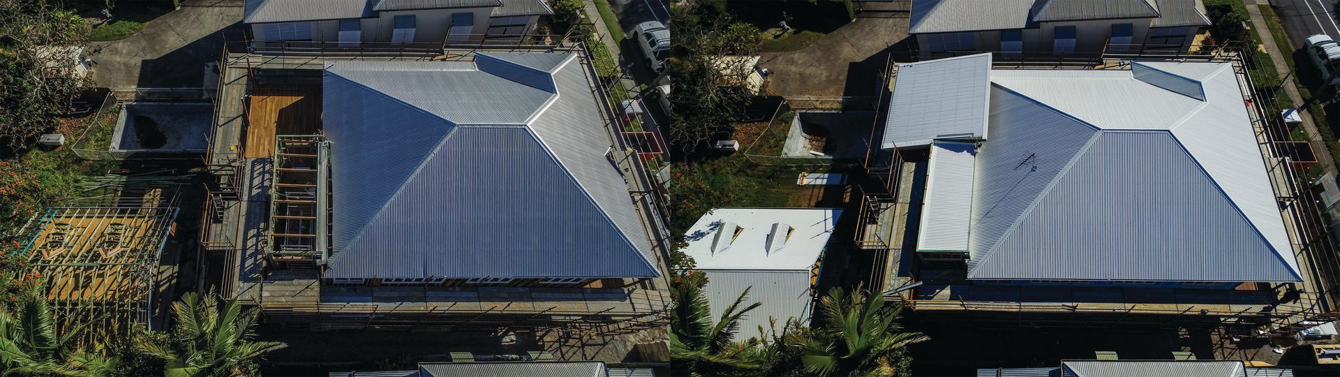 Aerial view of two houses with gray metal roofs and surrounding trees in a suburban neighborhood.