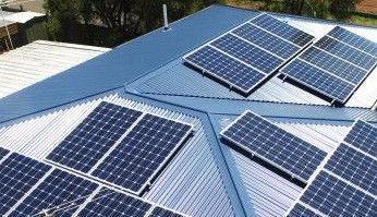 Blue rooftop solar panels on a corrugated metal roof