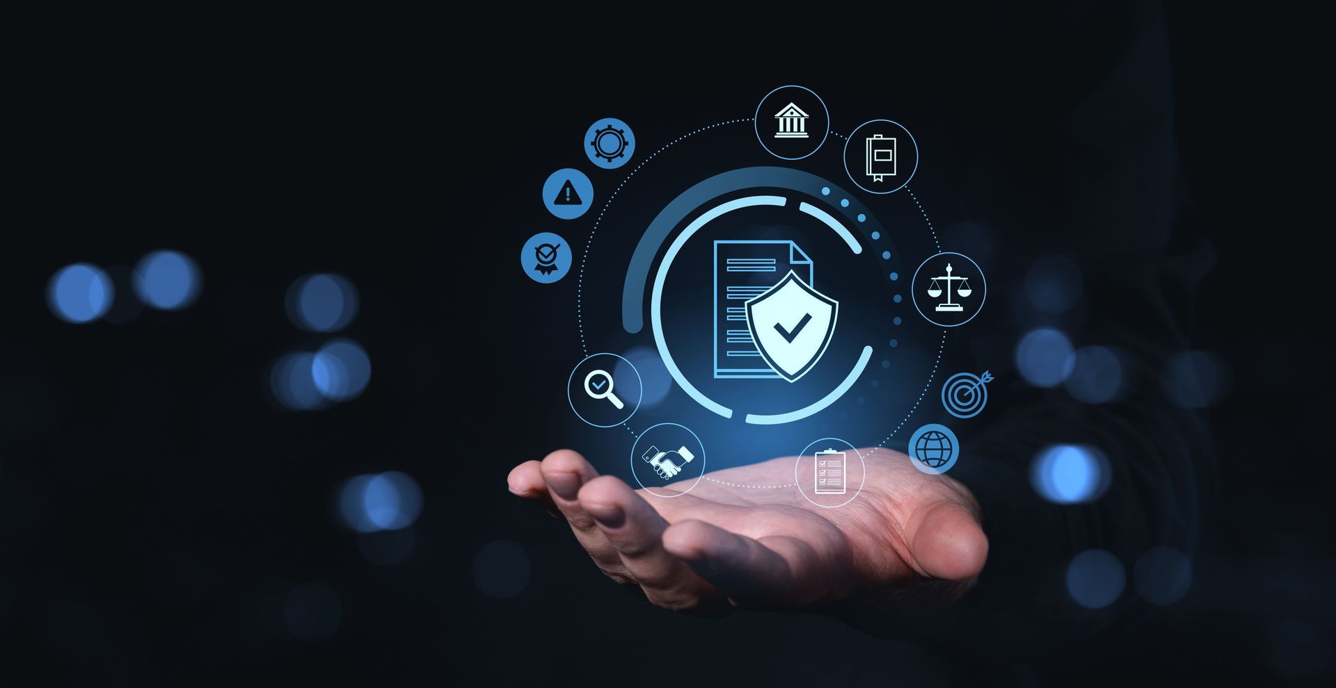 Hand holding a digital document with shield icon, surrounded by other digital icons, likely related to data security.