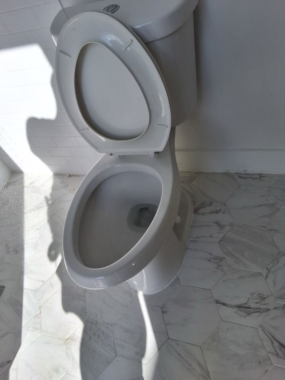 Three white water filters mounted on copper pipes with gauges in a utility room.