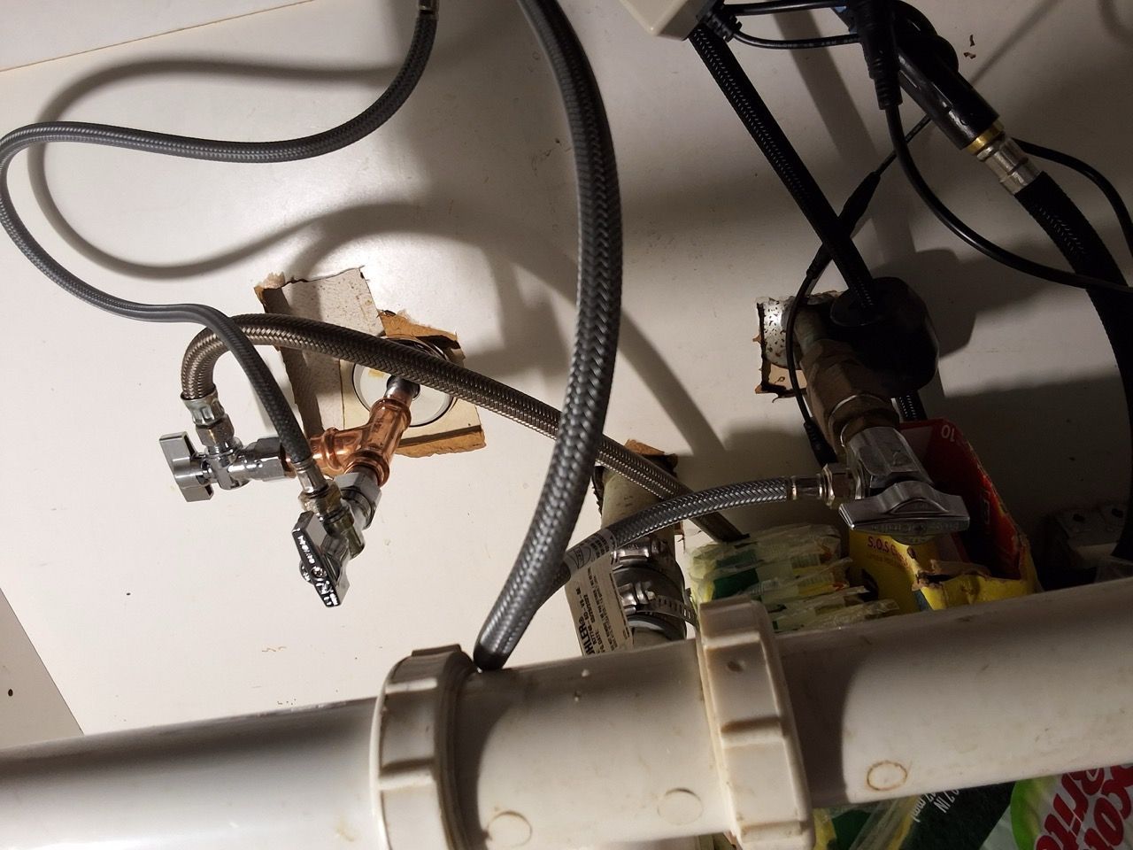 Exposed electrical wiring and components mounted above a white pipe ceiling.