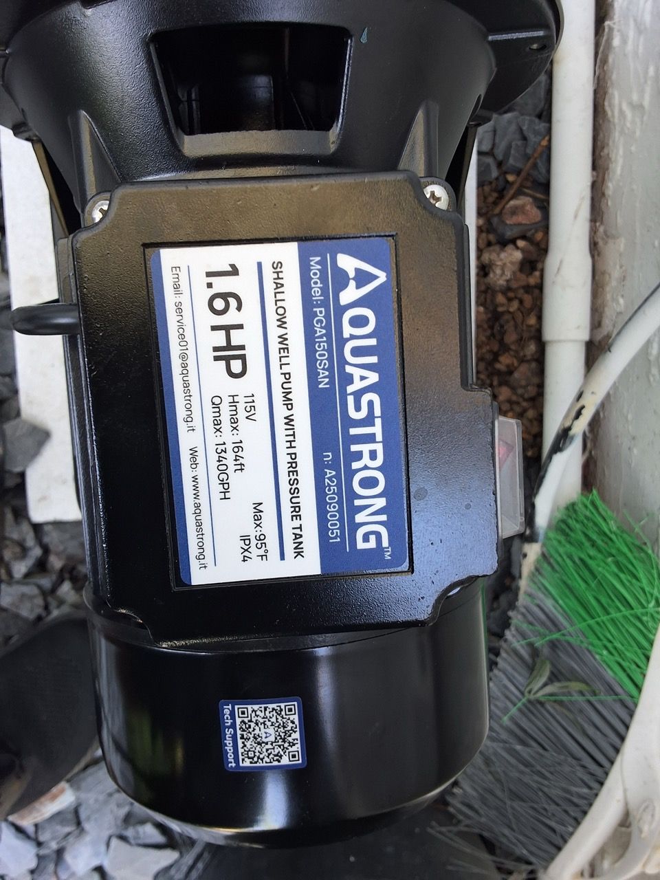 Aquastrong 1.5 HP black electric motor with blue label, mounted on a wet outdoor surface