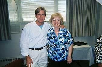 A man and a woman are posing for a picture in a room.