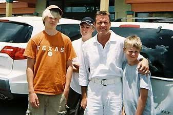 A man wearing a texas shirt is posing for a picture with his family