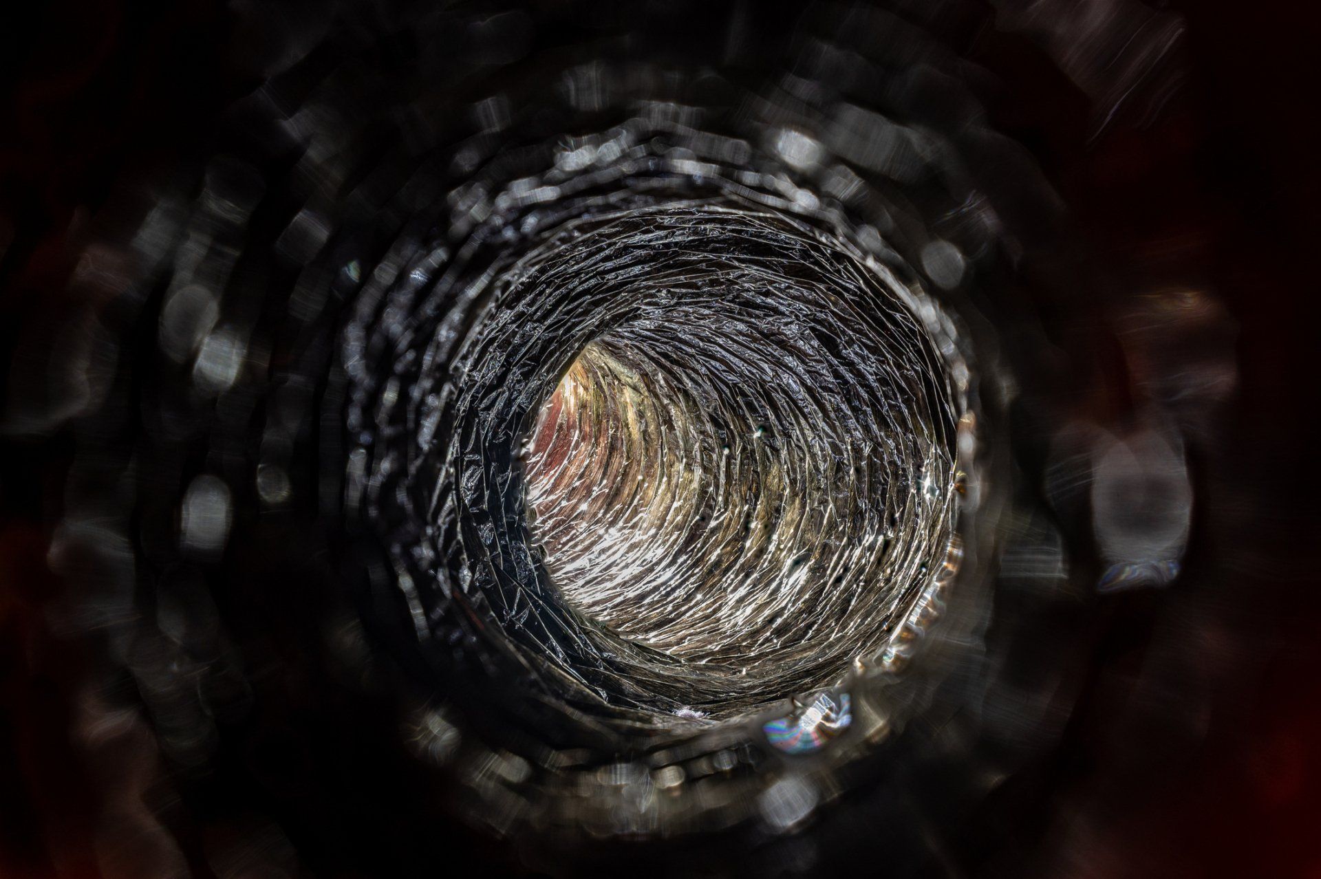 Man Cleaning The Dryer Vent — Sandpoint, ID — Indoor Air Care