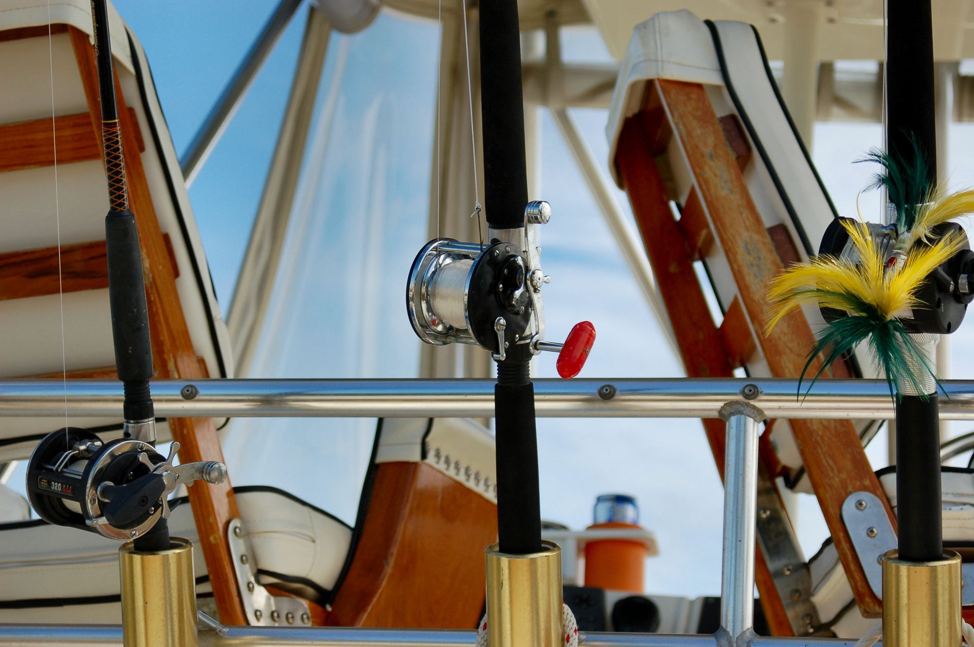 Several fishing rods are hanging on a boat