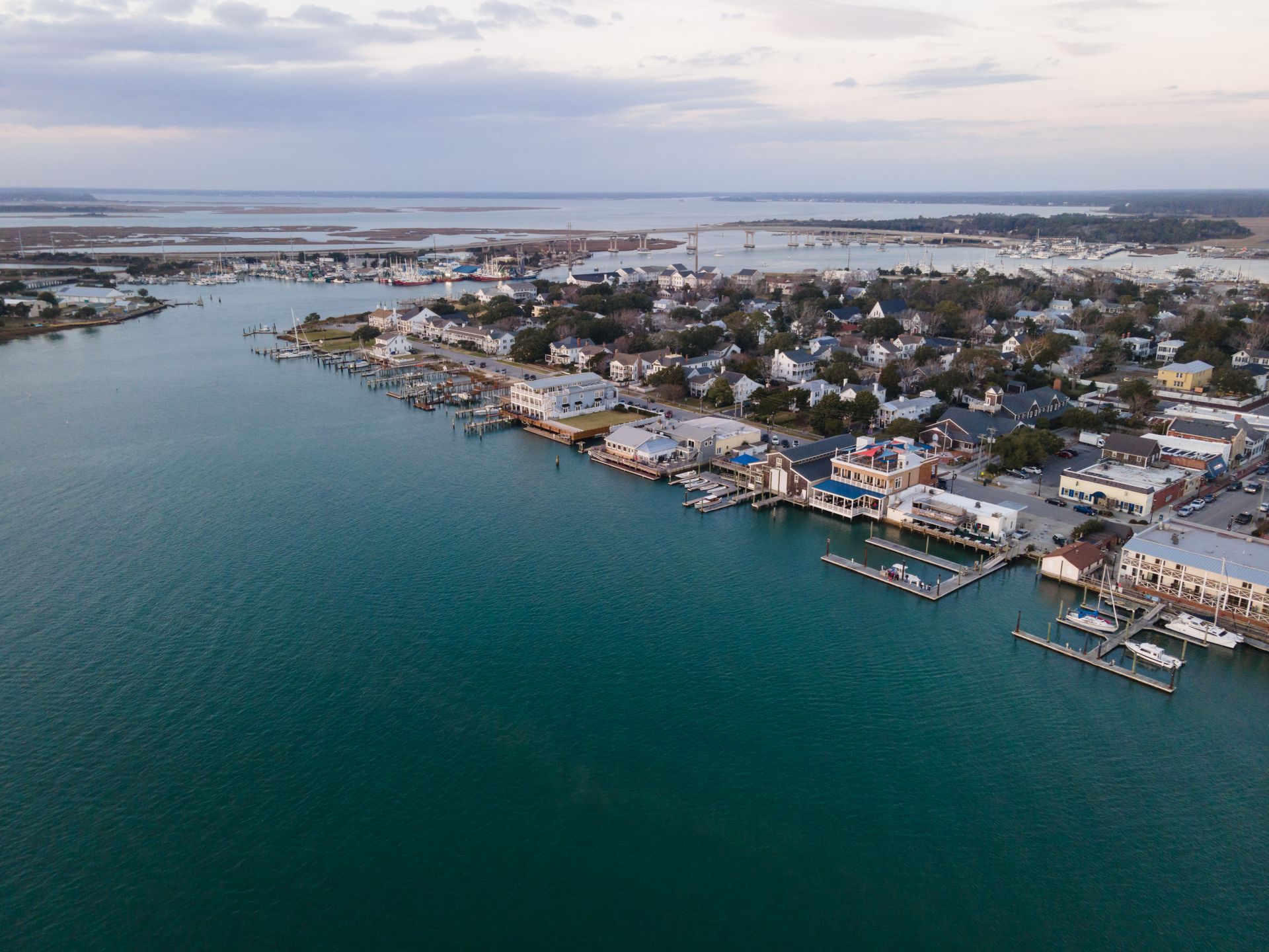An aerial view of a small town next to a body of water.