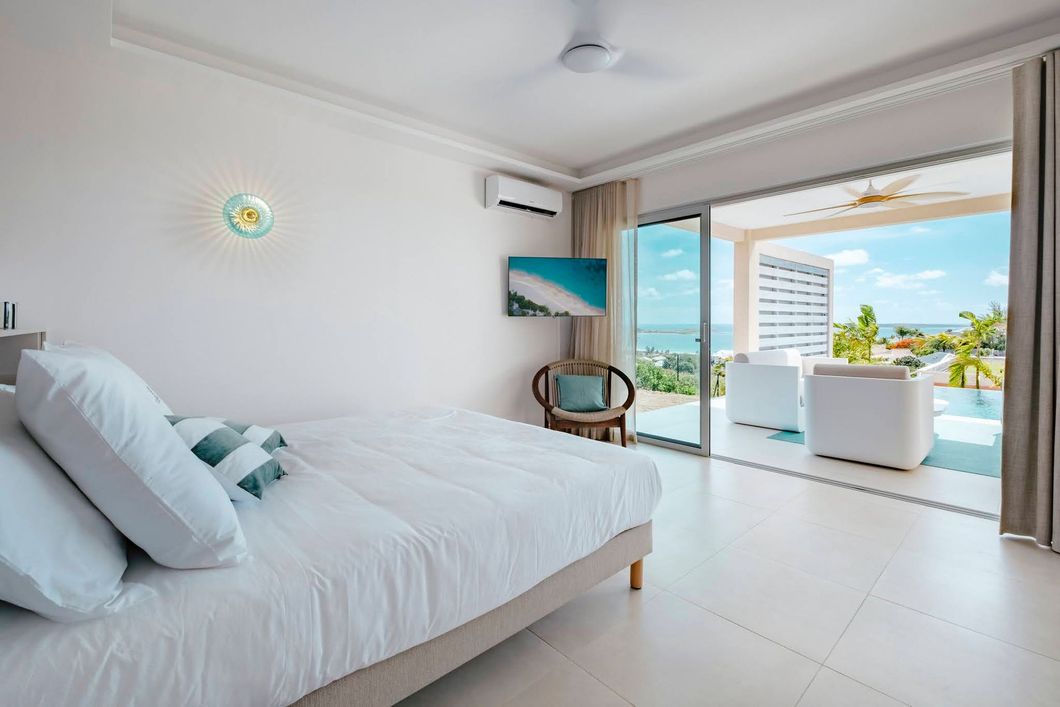 Two-story modern villas with rooftop gardens, swimming pools, and palm trees, on a grassy plot.