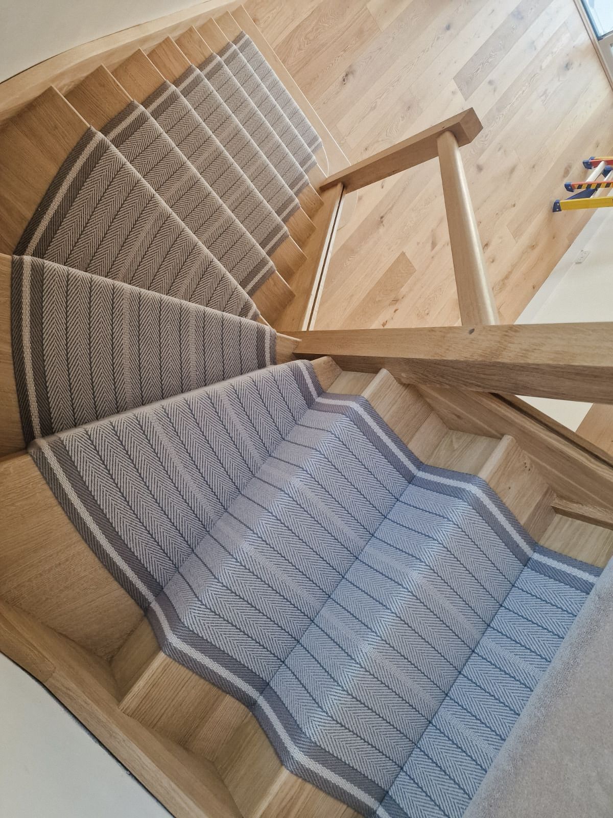 Roger Oates stair runner on modern wooden stairs