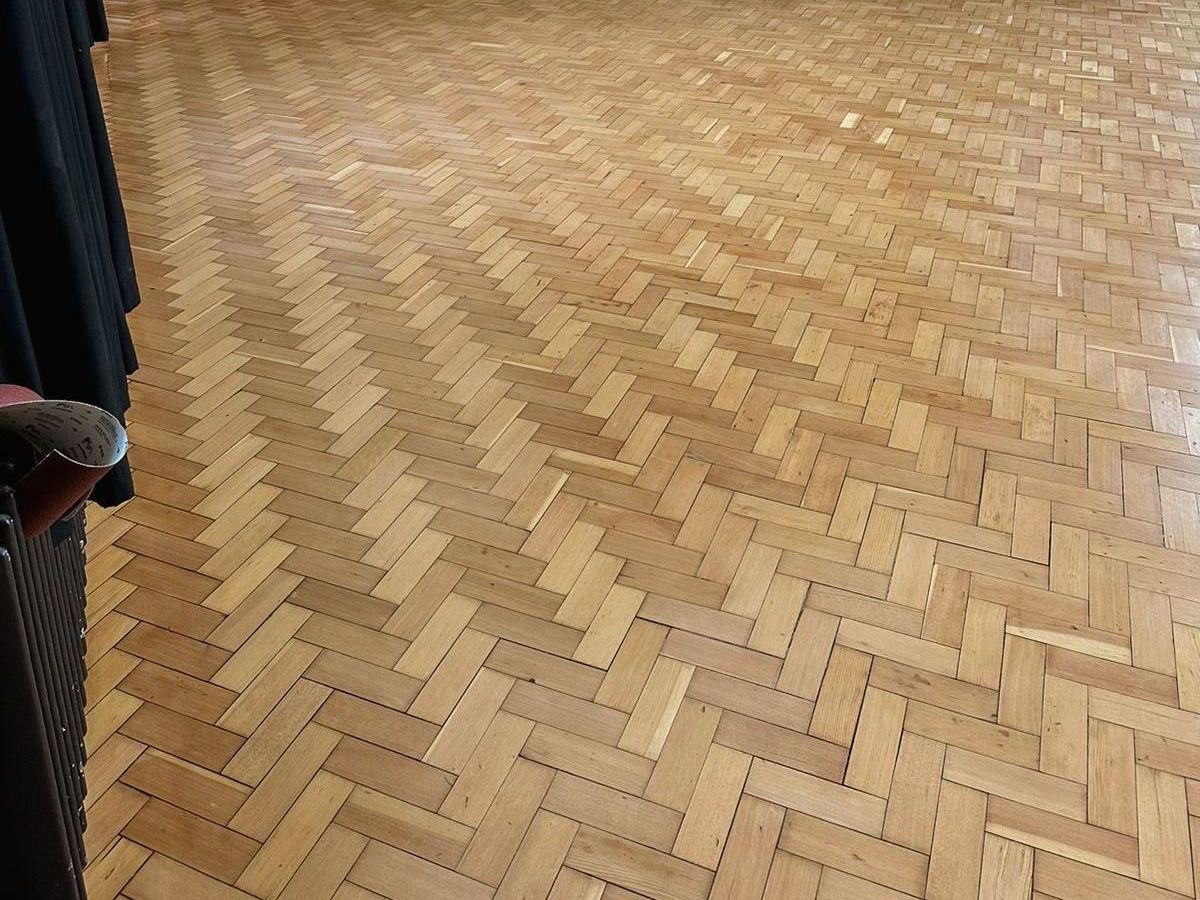 Restoration of wood herringbone floor in Kingsbridge School
