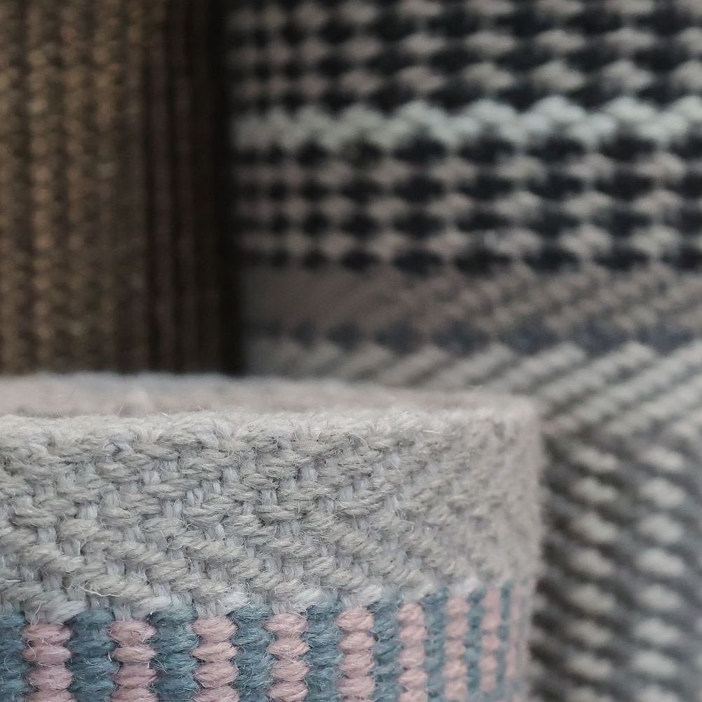 Roger Oates Stair Runner rolled up in basket in flooring showroom