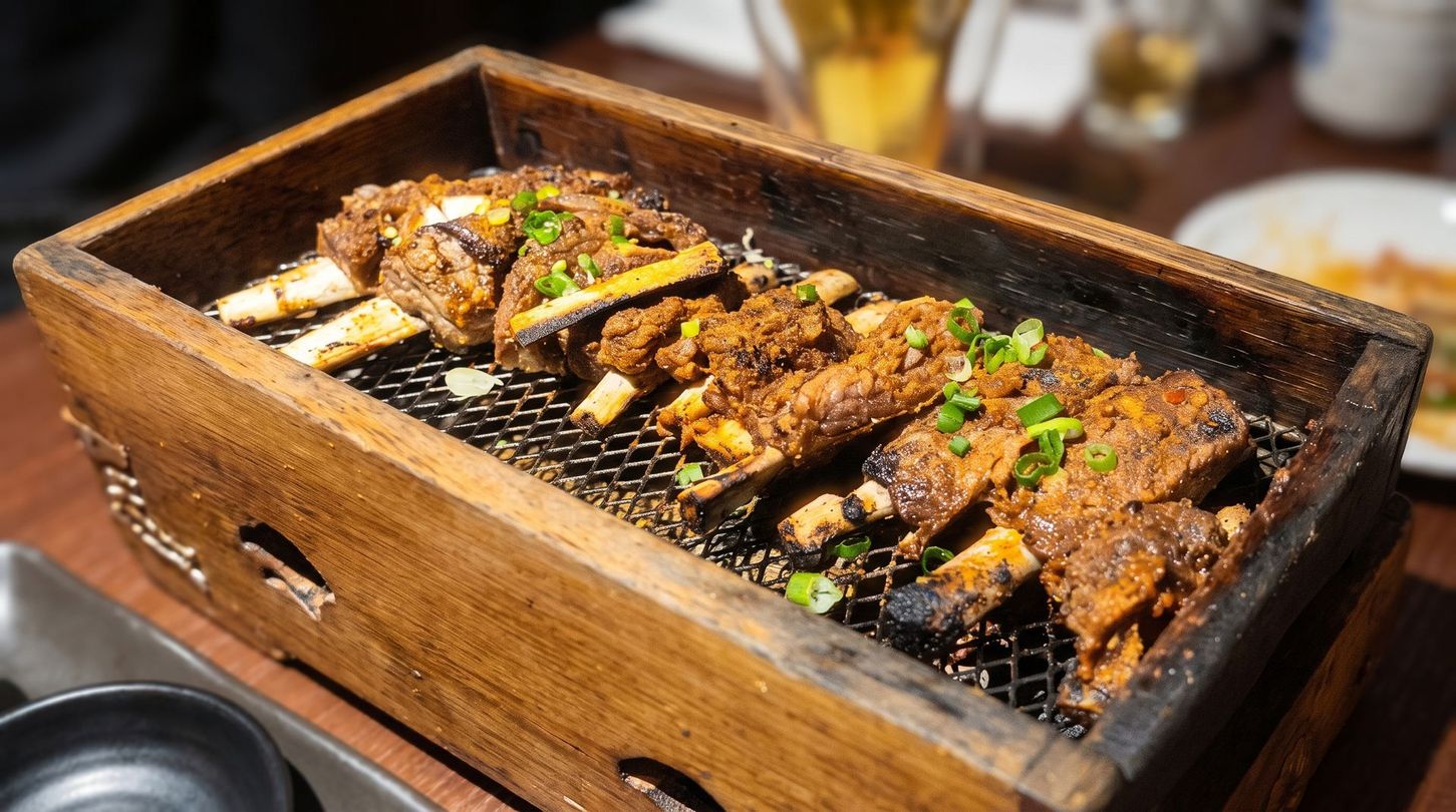 Grilled meat skewers in a wooden tray, garnished with chopped green onions on a tabletop grill