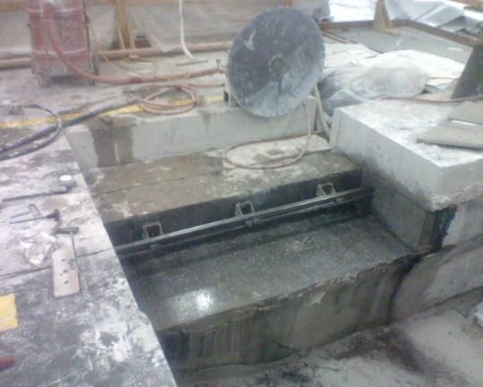 A close up of a machine cutting a hole in the ground.