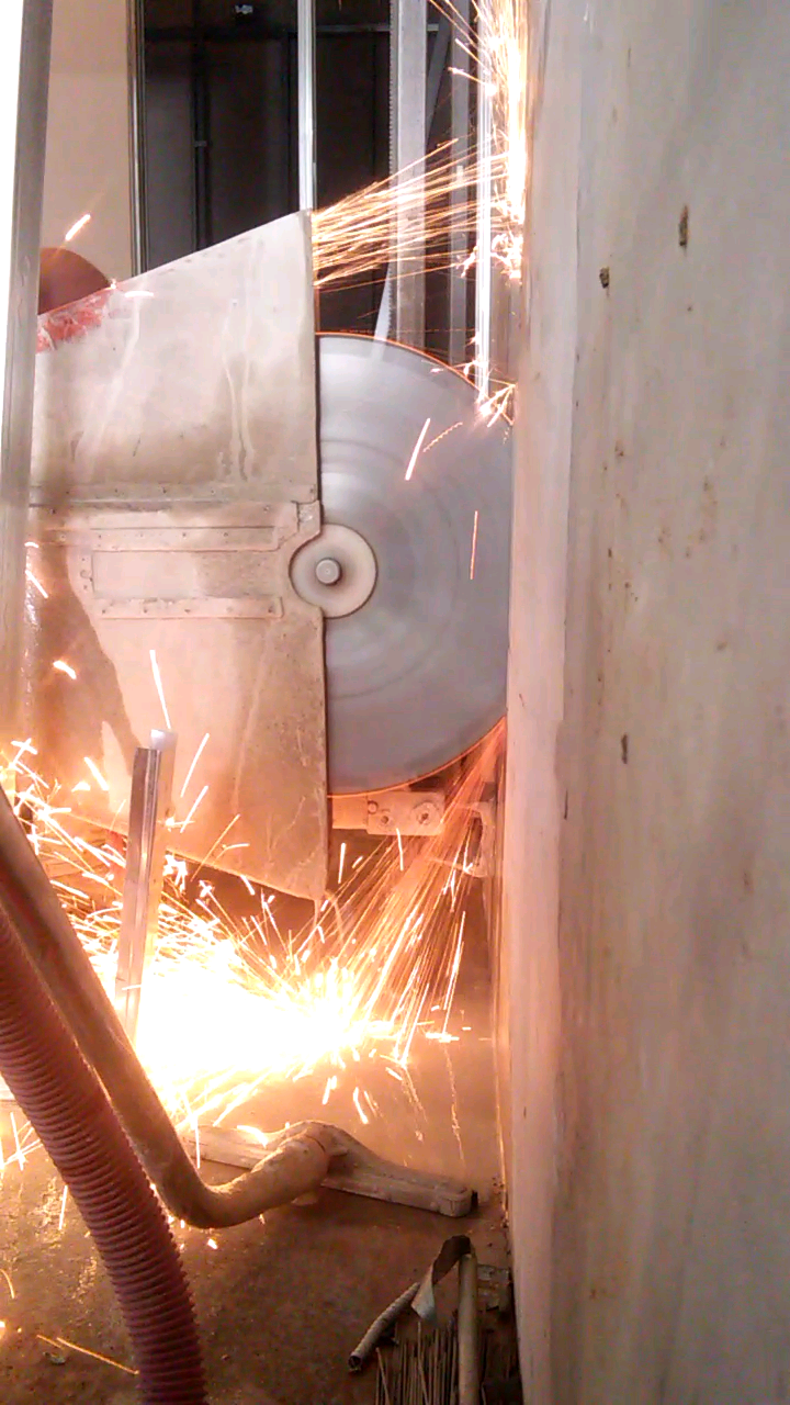 A close up of a machine cutting a hole in the ground.