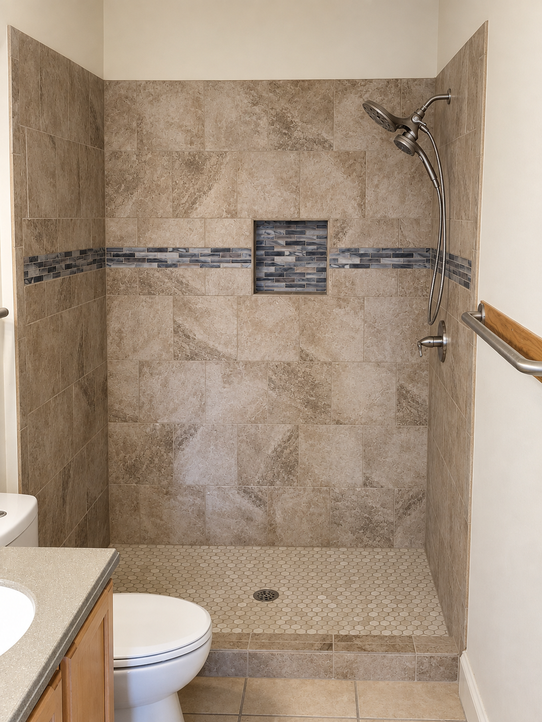 Accessible walk-in shower with beige tile, chrome fixtures, and a built-in bench next to a toilet.