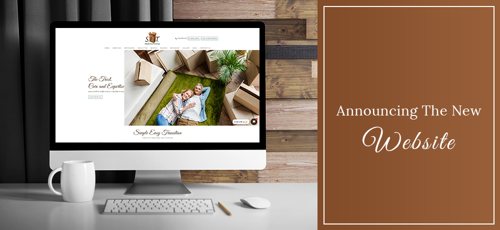 Announcing the new website, with computer screen display on a desk, next to a brown panel.