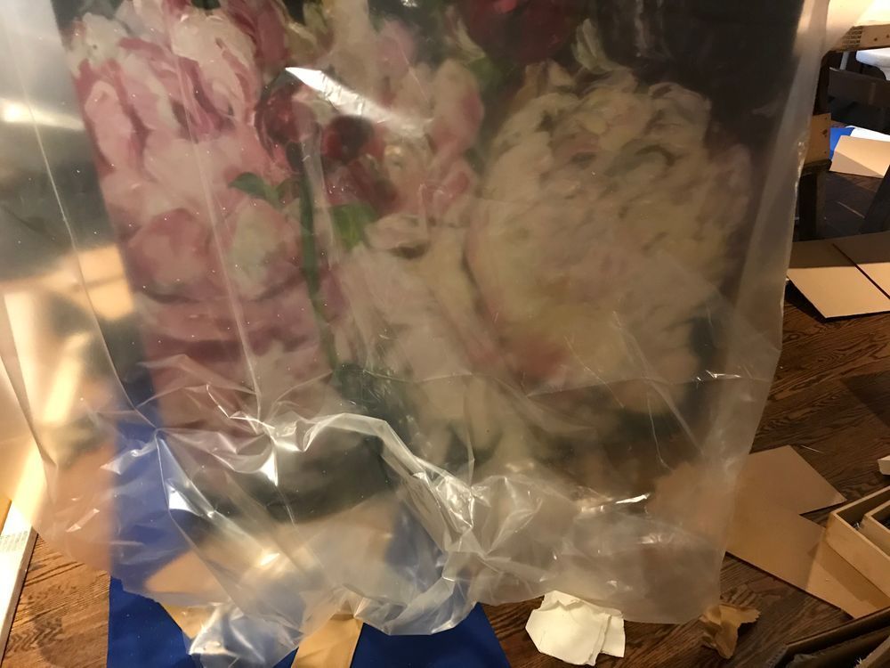 Flowers wrapped in clear plastic. Pink and white petals visible.