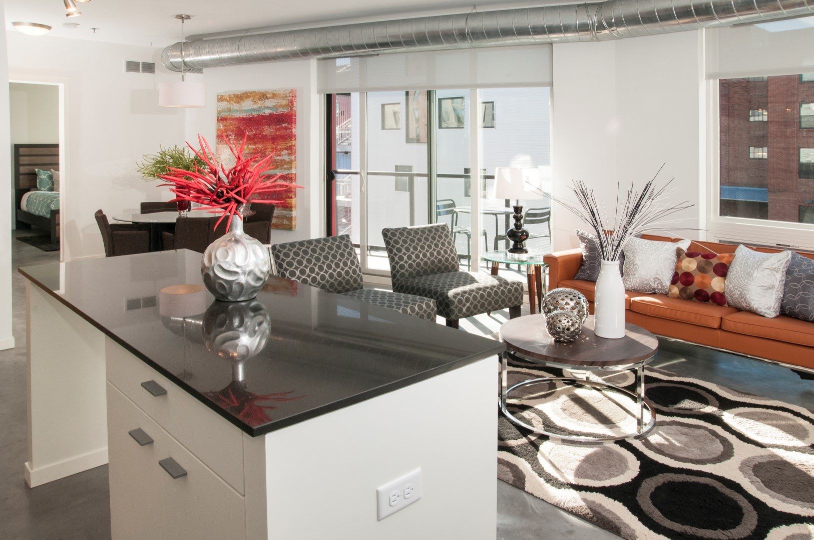 Model apartment living room and kitchen at Brunsfield North Loop