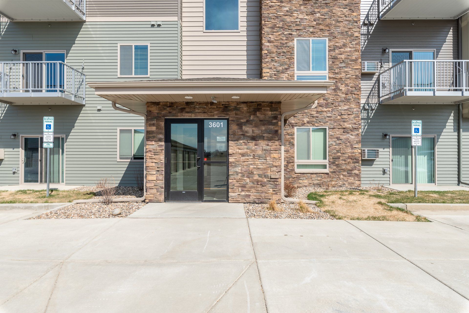 Exterior entrance of apartment building with brick wall