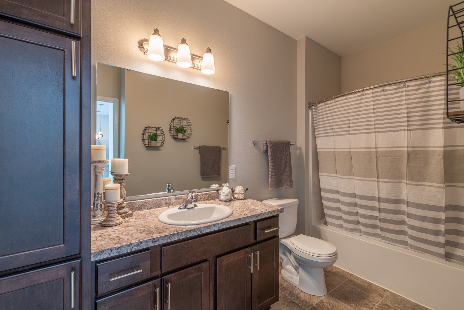 Bathroom with granite counters, tub shower combo