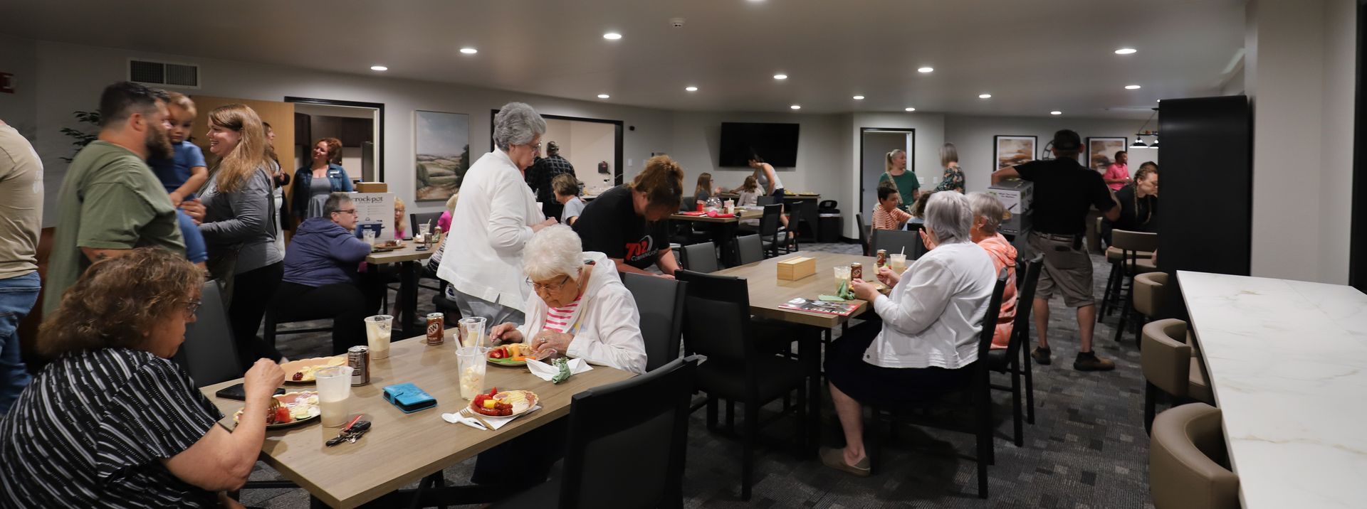 Residents at Dakota Park gather for the unveiling of the updated Dakota Prairie Community Room