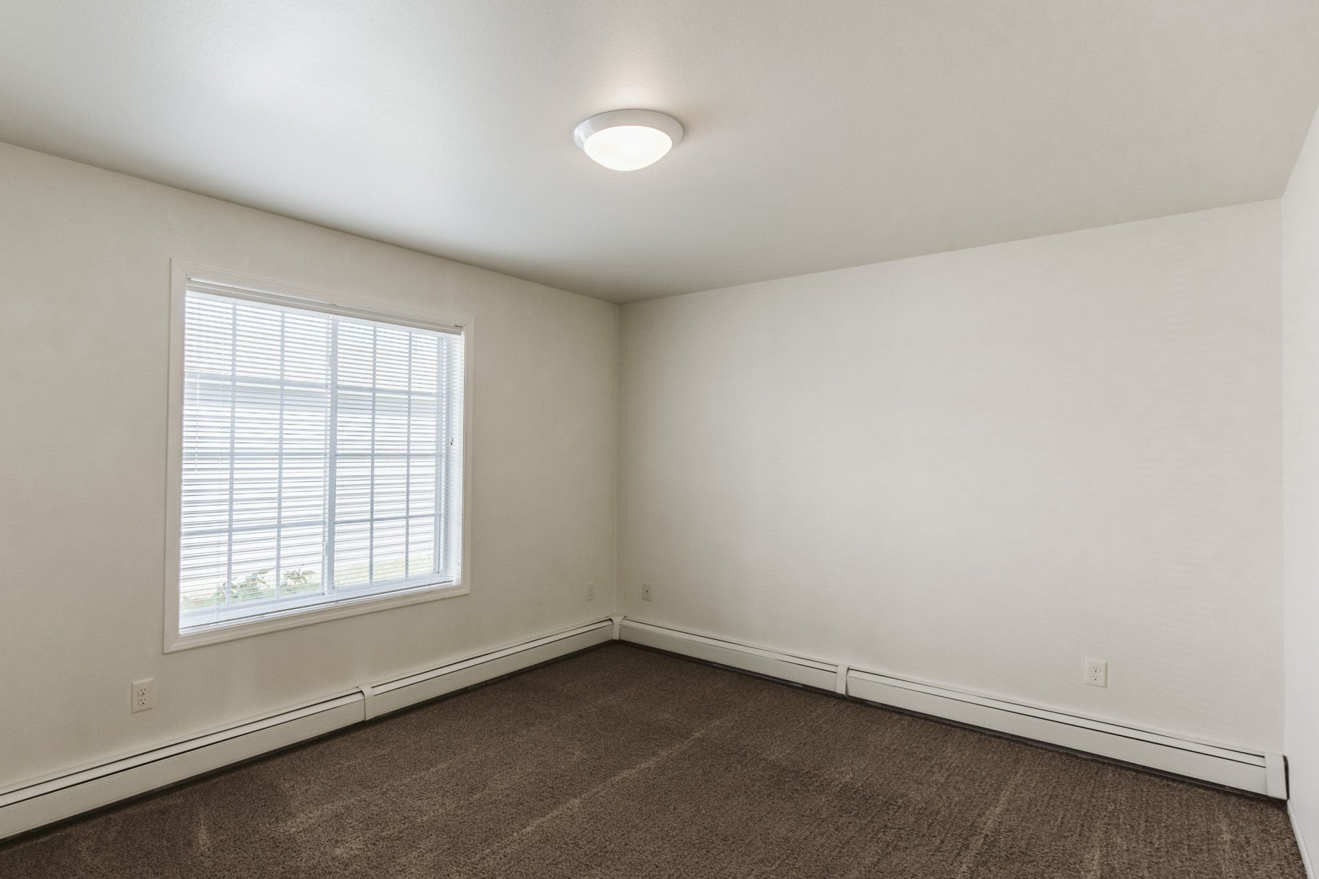 View of window and light fixture in bedroom