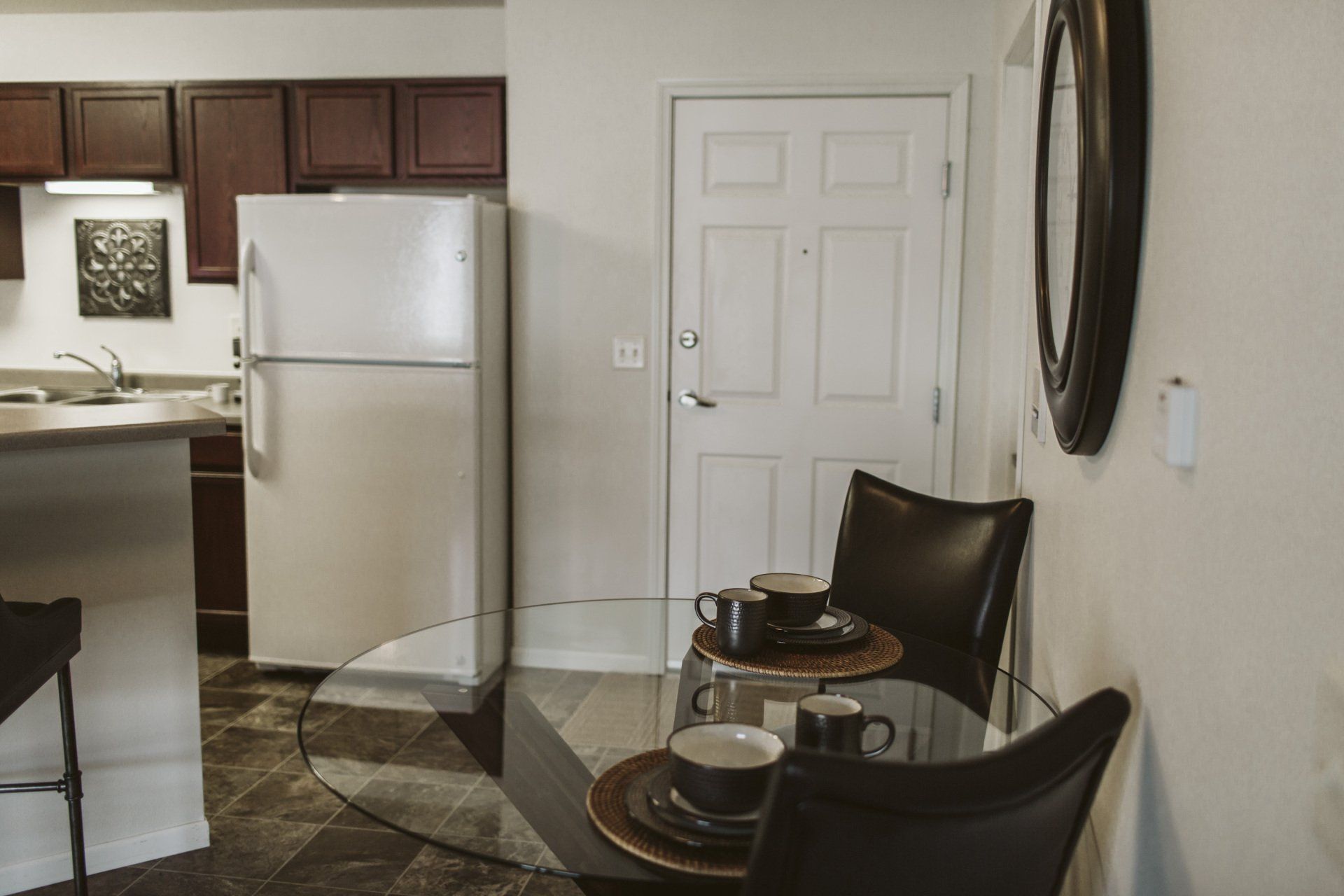 View of closet, dining table, and refrigerator