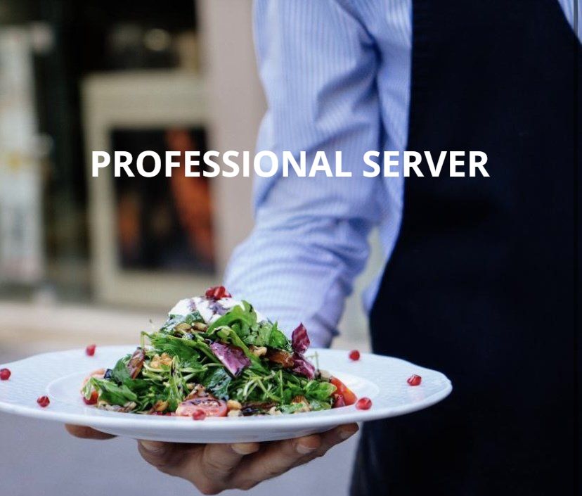 A professional server is holding a plate of salad
