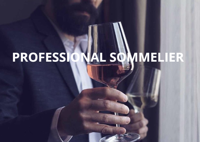 A professional sommelier is holding a glass of wine