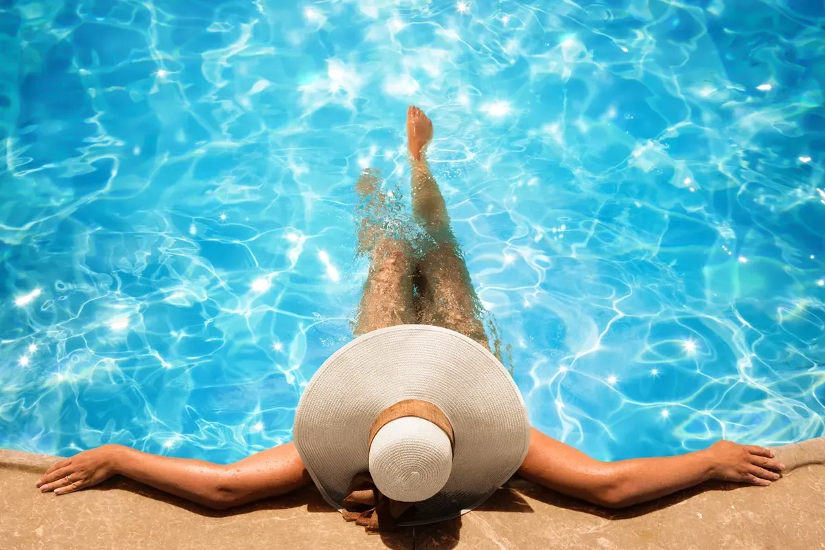 Woman relaxing in a swimming pool Woman relaxing in a swimming pool