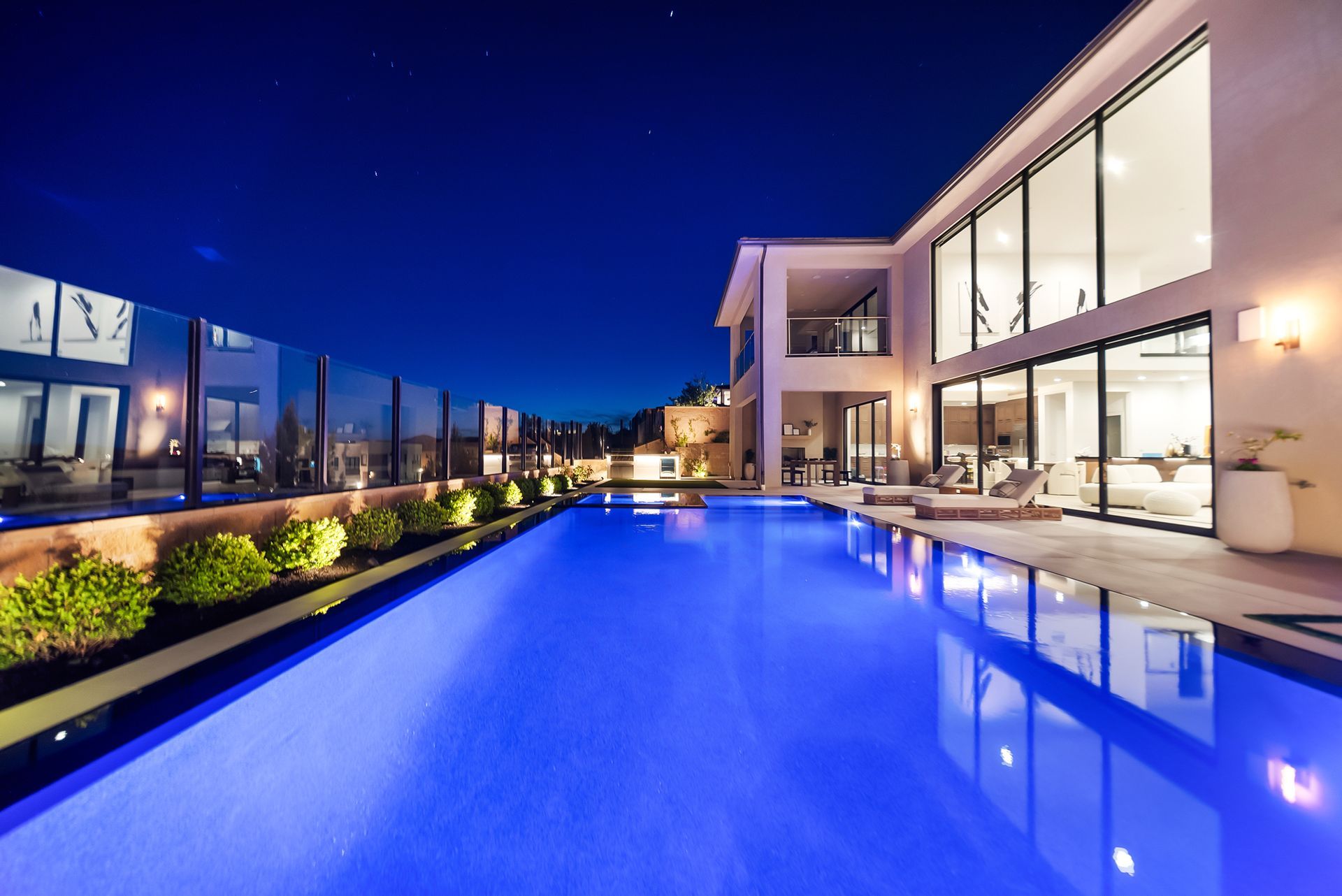 Luxury pool design and construction in Porter Ranch, Los Angeles. Design and build by Westmod. Night time photo of completed custom pool and outdoor living space.