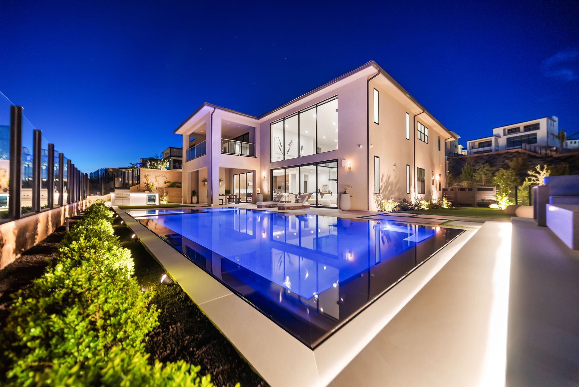 Luxury pool design and construction in Porter Ranch, Los Angeles. Design and build by Westmod. Night time photo of completed custom pool and outdoor living space.