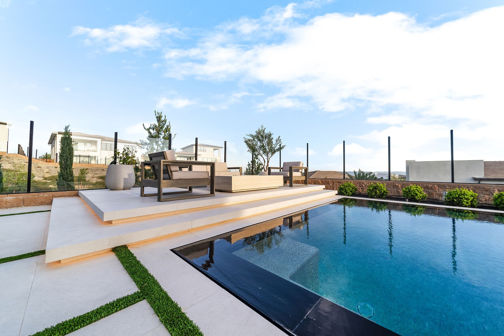 Luxury pool design and construction in Porter Ranch, Los Angeles. Design and build by Westmod. Day time photo of completed custom pool and outdoor living space.