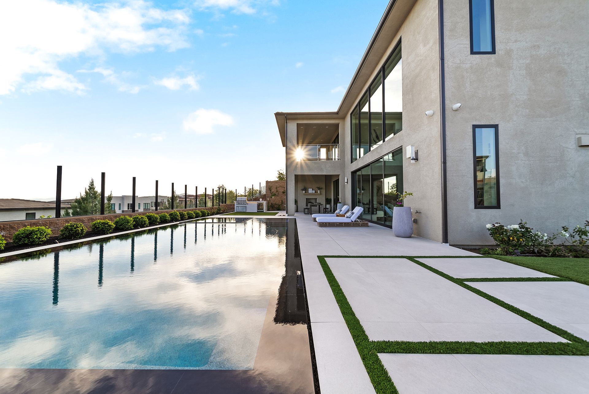 Luxury pool design and construction in Porter Ranch, Los Angeles. Design and build by Westmod. Day time photo of completed custom pool and outdoor living space.