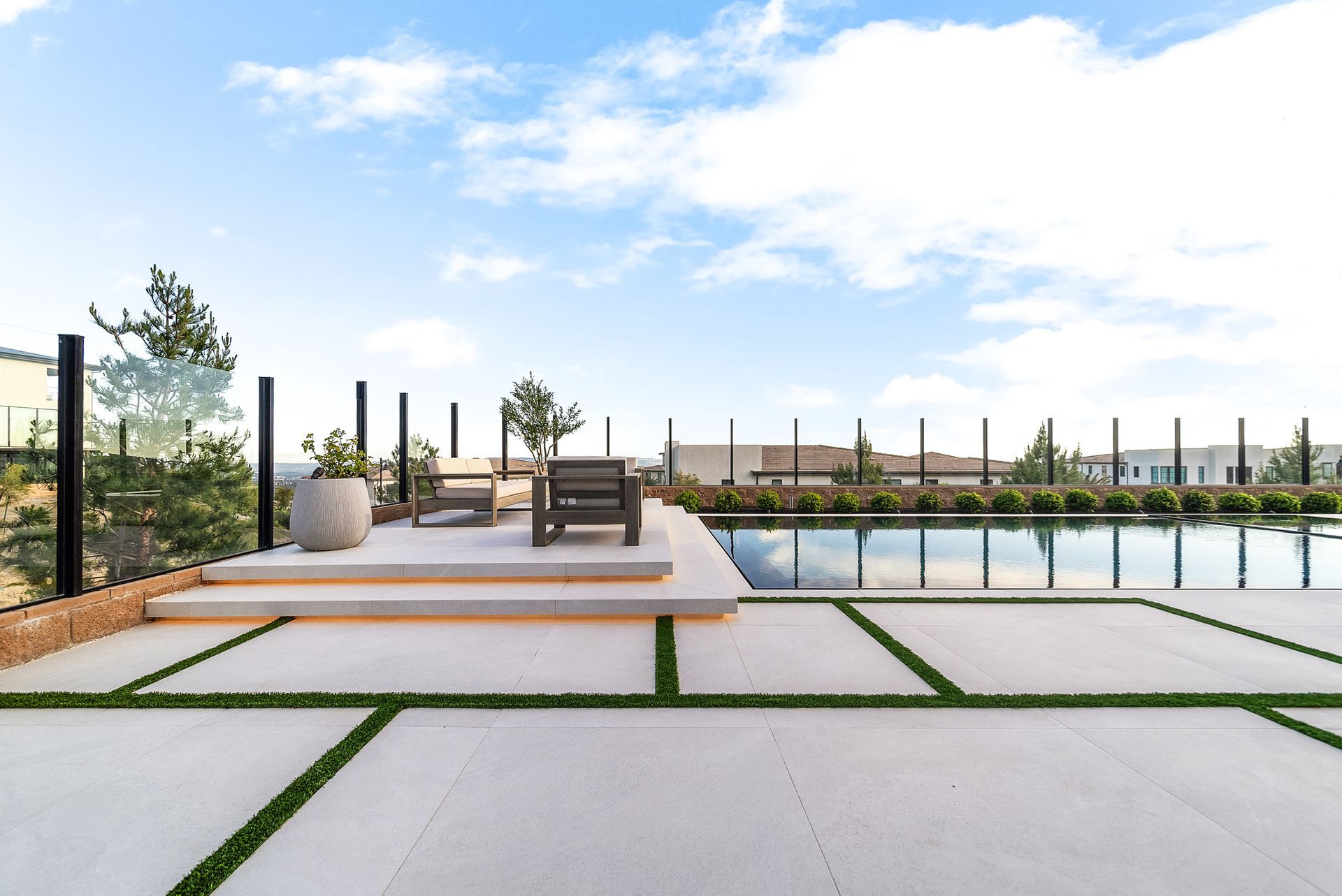 Luxury pool design and construction in Porter Ranch, Los Angeles. Design and build by Westmod. Day time photo of completed custom pool and outdoor living space.